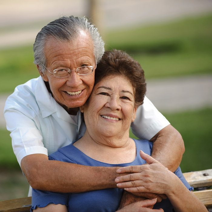 An older couple sitting outdoors together